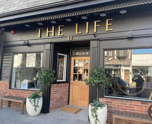 The Life boutique storefront in downtown Westfield NJ featuring upscale clothing and home furnishings with elegant exterior design