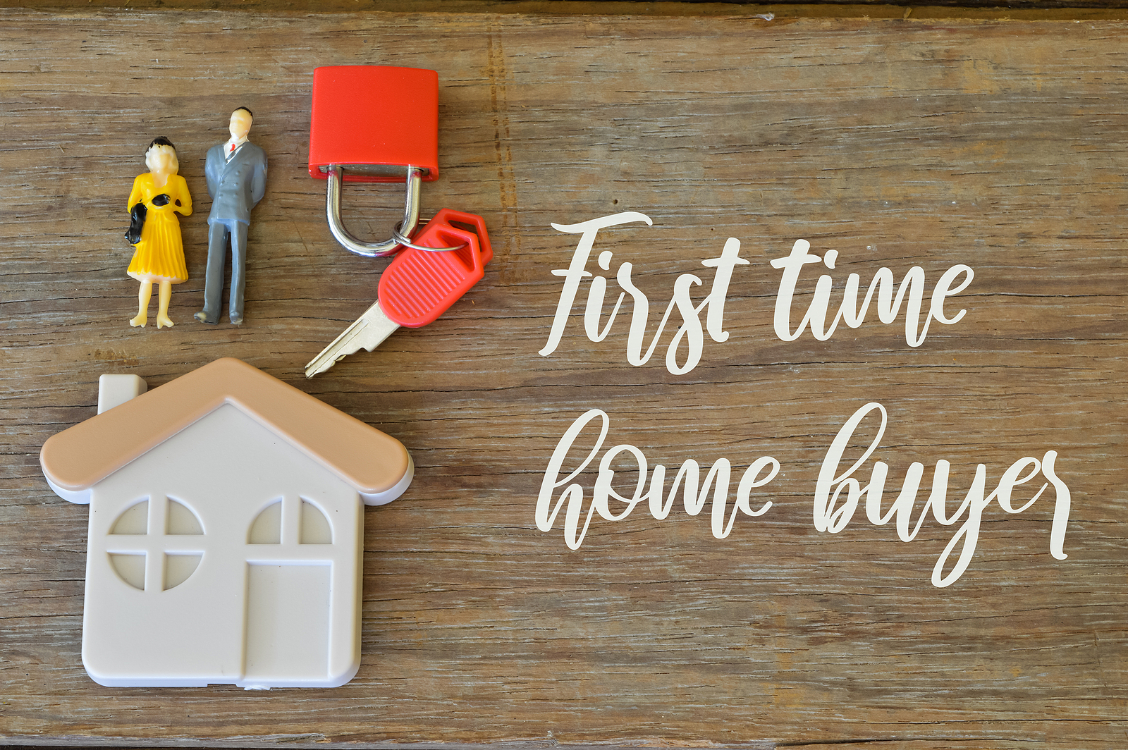 First-time home buyers concept with house model and keys representing buying a home in Westfield NJ